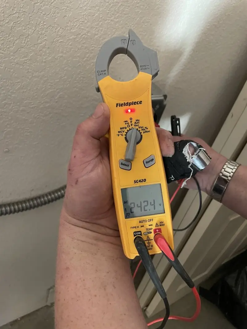 Voltage testing with clamp meter during Outlet Installation in Glasgow Village